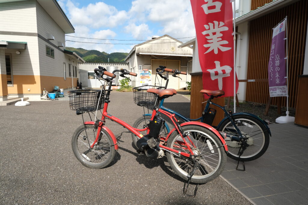 Rental bikes in front of a store sign