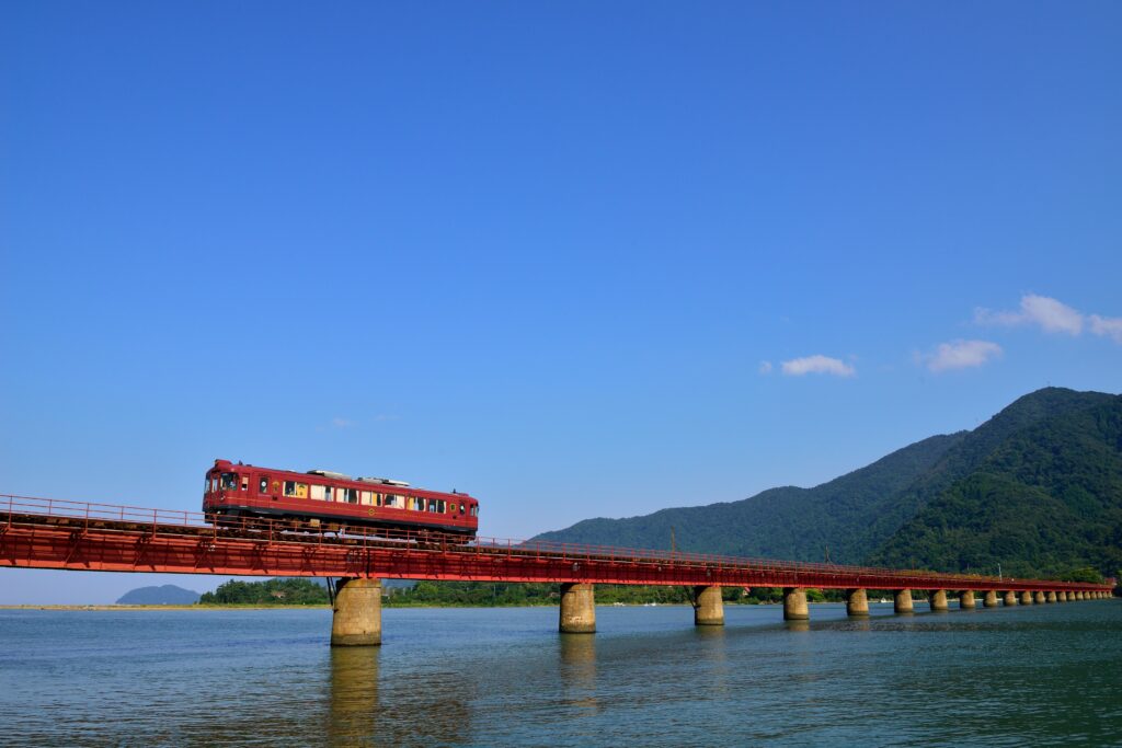 The Kyoto Tango Railway traveling over the Maizuru Bay