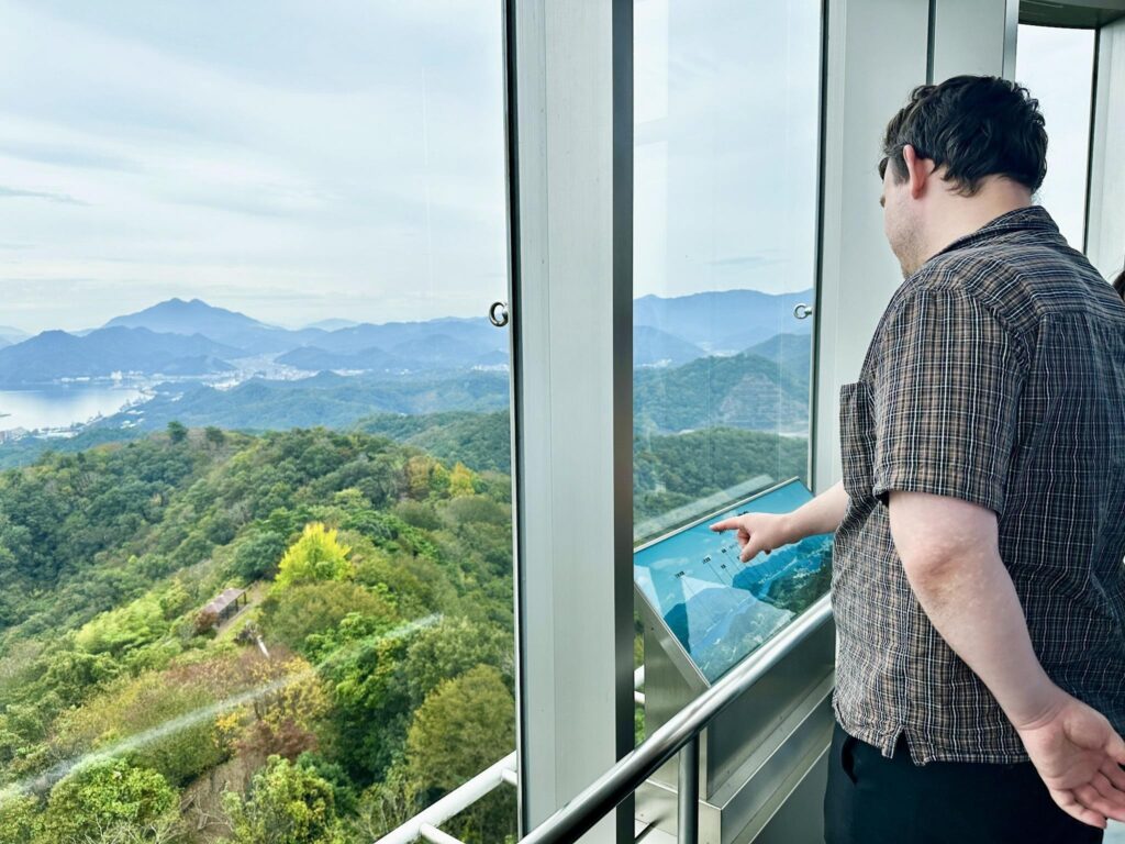 A person points to a placard at the top of Goro Sky Tower in Maizuru City, Kyoto